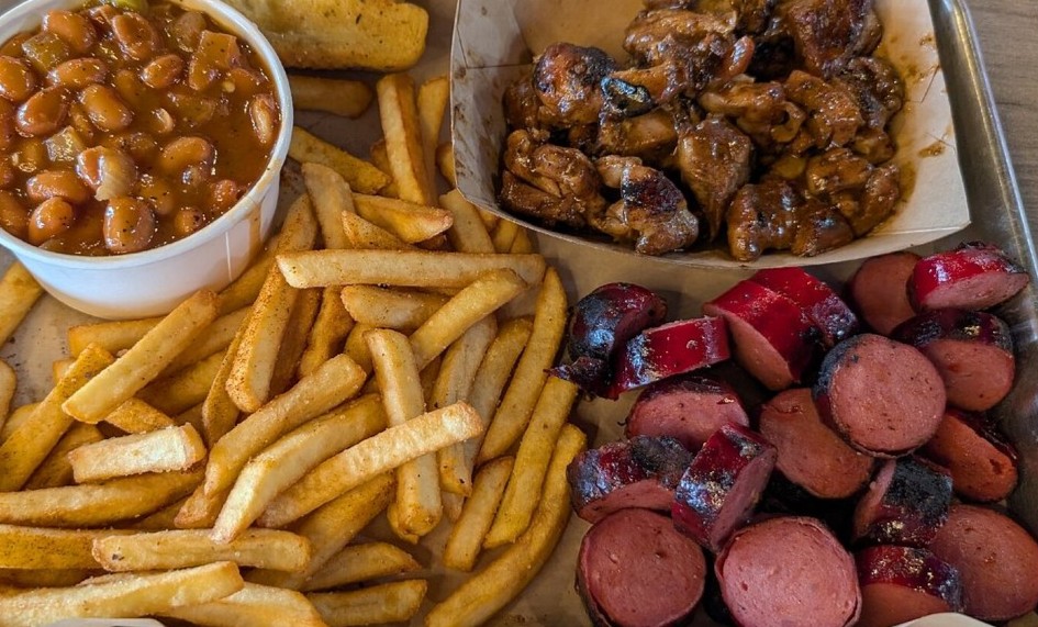 Prime BBQ platter with brisket, rib tips, and sides